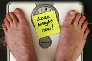 A scale with the words "lose weight now" on it