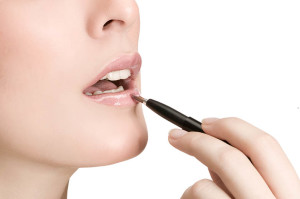 A woman using lip gloss